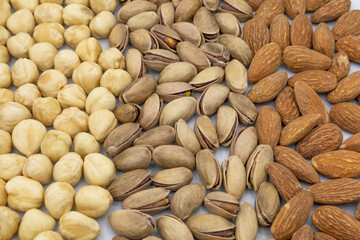 Different nuts collection hazelnut, almond and pistachios isolated on white background