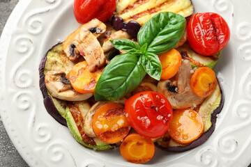 Plate with grilled vegetables and basil, closeup