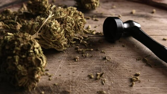 Dry CBD cannabis with metal smoking pipe