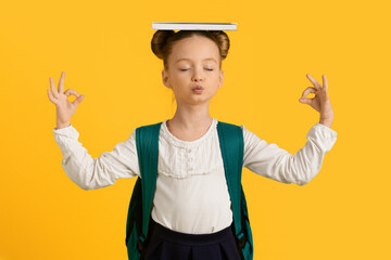 Keep Calm. Little Schoolgirl Meditating With Book On Head And Closed Eyes