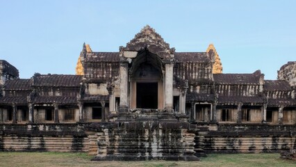 The ruins of a medieval Khmer structure stand alone in the ancient city of Angkor, Cambodia,...