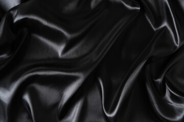 Silk fabric, abstract wavy black satin fabric background.