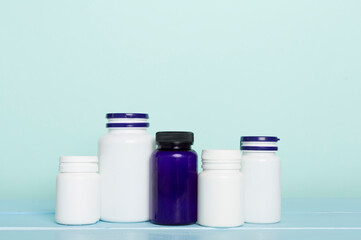 Plastic bottles for vitamins on wooden table