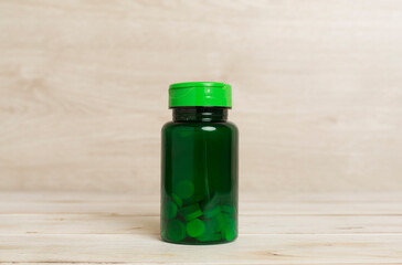 Plastic bottle for vitamins on wooden table