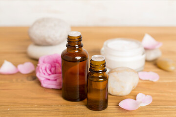 Spa composition with pink roses on wooden table