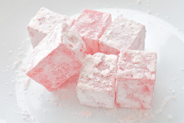 Turkish delight or lokum on a white plate.