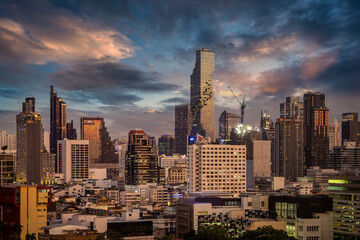 Fototapeta premium The urban skyline of the city center of Bangkok, Thailand, with the modern skyscrapers during sunset time