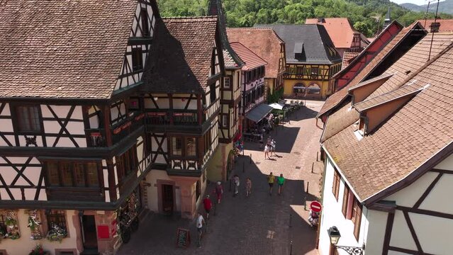 Aerial Drone Shot of the Streets in village of Kaysersberg in Alsace in a day. Summer in France, Castle above