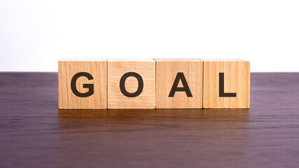 goals written in wooden cubes. conceptual word collected of of wooden elements with the letters. stock image, brown background