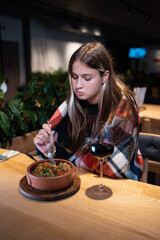 upset unhappy female eating food in restaurant