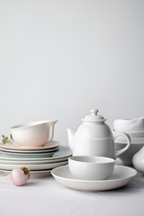 Household ceramic items. Pastel color crockery: stacks of bowls and mugs. AI generated