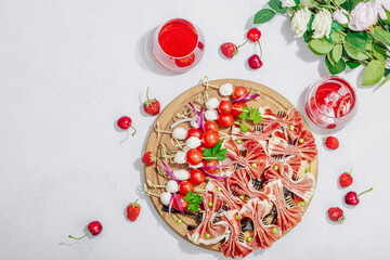 Picnic food concept. Basket with wine and baguette, set of snacks on skewers. Meat, cheese