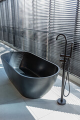 modern minimalistic soft design room interior in Japanese style in beige and black colors. stylishly detached bathroom by a huge panoramic window with blinds