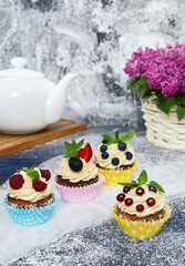 A delectable cupcake adorned with a vibrant assortment of fresh fruits. The moist cake base perfectly complements the burst of fruity flavors. 