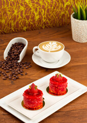 Indulge in the exquisite combination of a moist strawberry cake layered with luscious strawberry cream, perfectly paired with the rich aroma of cappuccino