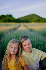 close-up portrait of children in summer against the background of a field with lavender