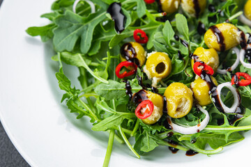 olive salad hot chili pepper, green mix lettuce, arugula meal food snack on the table copy space food background rustic top view