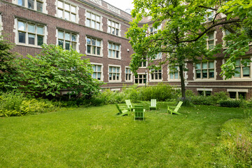 Lawn chairs on the grass next to an academic building 
