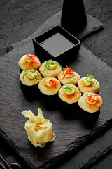 Baked norimaki with cheese caps served with ginger and soy sauce
