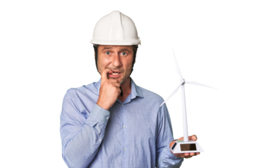 A middle-aged architect man holding a windmill model biting fingernails, nervous and very anxious.