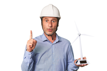 A middle-aged architect man holding a windmill model having some great idea, concept of creativity.