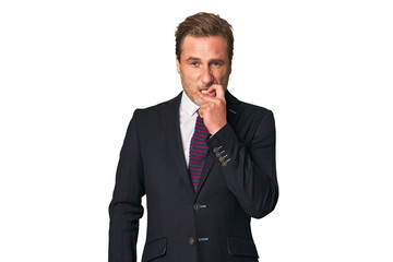 A middle-aged businessman isolated biting fingernails, nervous and very anxious.