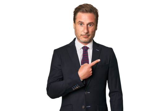 A middle-aged businessman isolated smiling and pointing aside, showing something at blank space.