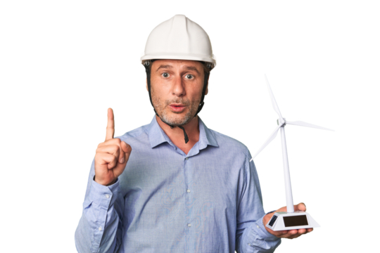 A middle-aged architect man holding a windmill model having some great idea, concept of creativity.