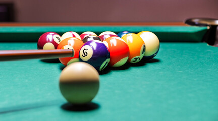 Colorful closeup of billiard balls and sticks on the table