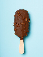 Chocolate and almonds stick ice cream isolated on cyan background