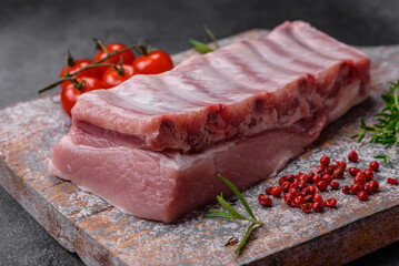 Raw pork ribs with meat with salt, spices and herbs