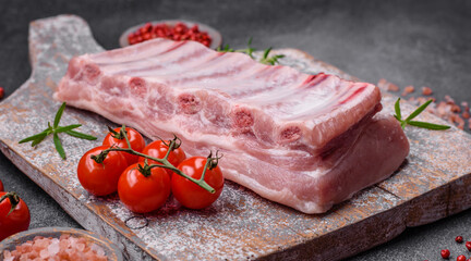 Raw pork ribs with meat with salt, spices and herbs