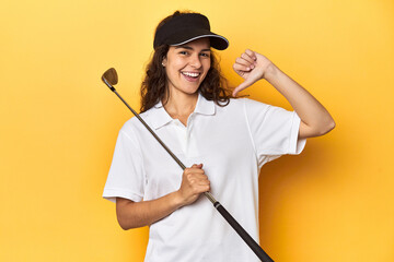 Golfer woman with cap, golf polo, yellow studio, feels proud and self confident, example to follow.