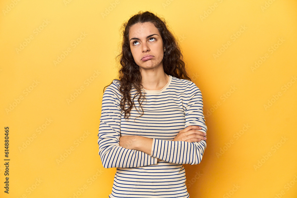 Canvas Prints young caucasian woman, yellow studio background, tired of a repetitive task. - Canvas Prints