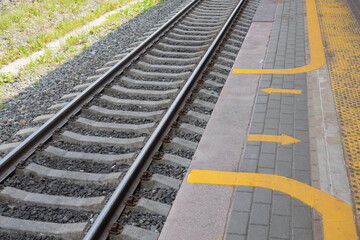 Fototapeta premium Railway tracks with a view of the platform