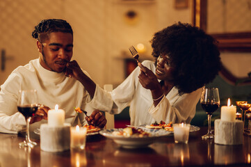 African american couple having romantic dinner date at home