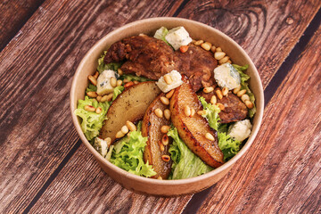 salad with chicken liver and dor blue cheese and pear on a wooden table for the menu 2