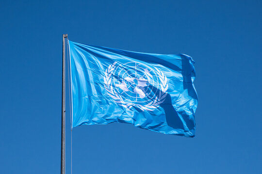 Rome, Italy - June 17, 2023 - ONU, United Nations flag waving in the wind. Sky background