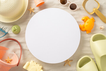 Delightful vacation with children by the sea: Top view photo featuring panama, sand toys, palm leaves, seashells, slippers and sunglasses on isolated sandy background with copy-space inside a circle