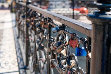 Fototapeta premium Padlocks on the bridge. Symbol of love, trust and family. The tradition of hanging a padlock on the wedding day.
