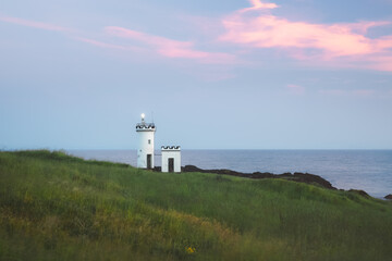 Fototapeta na wymiar Scenic seascape landscape at dusk of Elie Ness Lighthouse on the East Neuk Peninsula in coastal Fife, Scotland, UK.