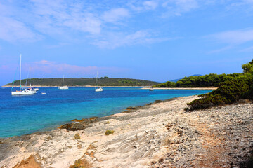 Beautiful wild beach and sailing boats on Proizd, small island near island Korcula, Croatia. 