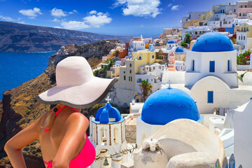 Woman in hat enjoying sun holidays on Santorini island in Greece