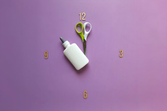 11 o'clock. ante meridiem. Study time. Back to school. Unusual watch with scissors and glue hour hands. Concept of study, deadline, schedule, creativity. Flat lay.