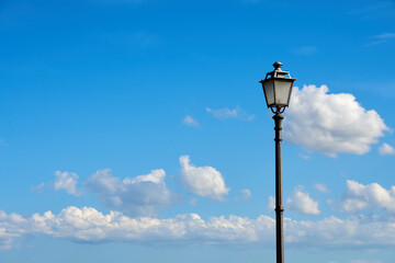 Fototapeta na wymiar lonely street lamp with white clouds