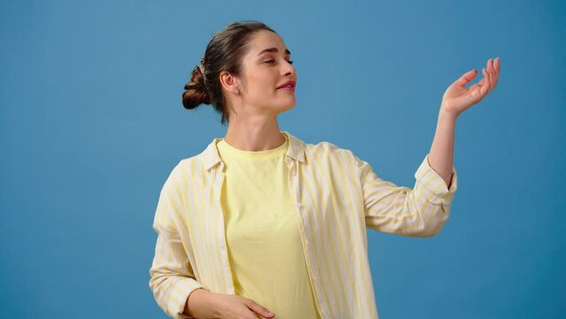 Beautiful young woman makes chef kisses saying Belissimo