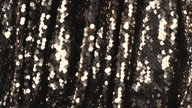 abstract beautiful festive shiny background with golden sparkles and bokeh. Fabric with sequins