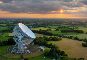 Goostrey, Cheshire, United Kingdom. 05.22.2023 Sunset reflects against the Lovell Telescope, Cheshire. Aerial Image. 22nd May 2023. - obrazy, fototapety, plakaty
