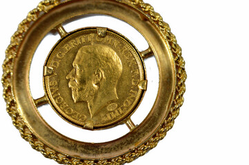 The sovereign is a British gold coin shape with a nominal value of one pound sterling, a bullion...