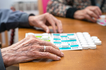 Close up of a senior man playing bingo at Nursing home. leisure game, support, assisted living, and retirement. High quality photo